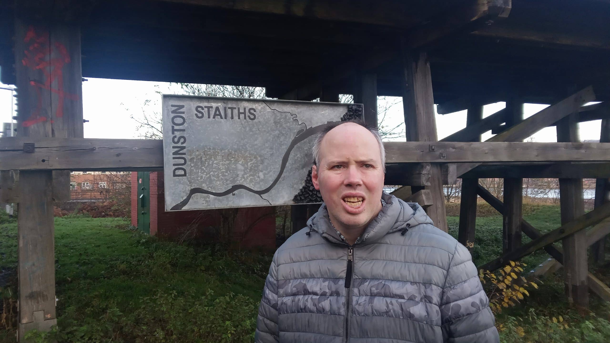 Person in front of a sign on a walk