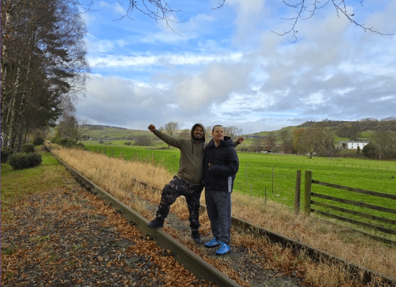Two people stood on old railway tracks